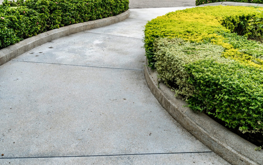 Spacious concrete driveway loop leading up to a large 2-story home in Lehigh Valley