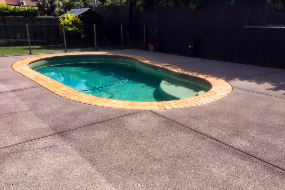 Private swimming pool with custom concrete decking in Lehigh Valley.