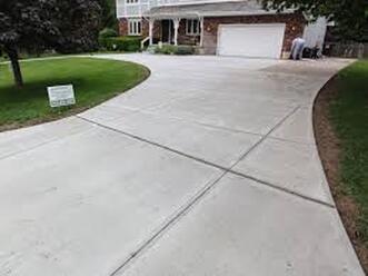 Spacious concrete driveway loop leading up to a large 2-story home in Lehigh Valley