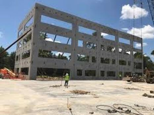 Four-story medical center being constructed with concrete walls.